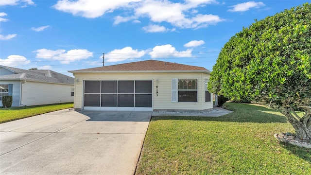 view of front of home featuring a garage and a front lawn