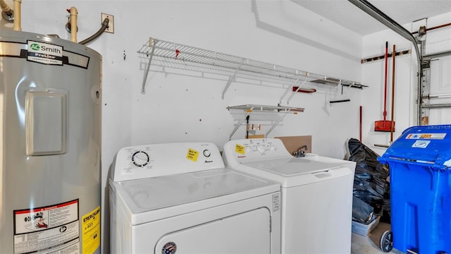 washroom with washing machine and dryer and electric water heater