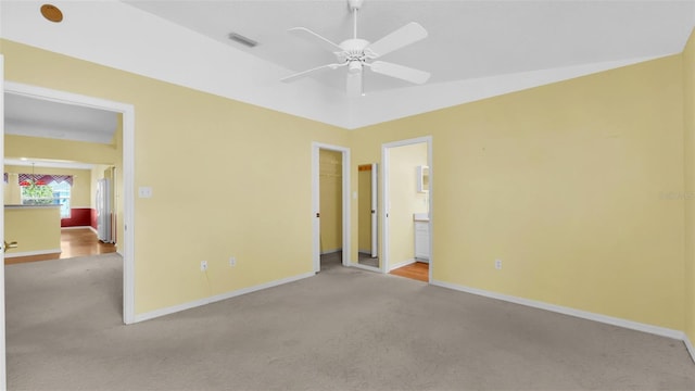 carpeted empty room featuring ceiling fan