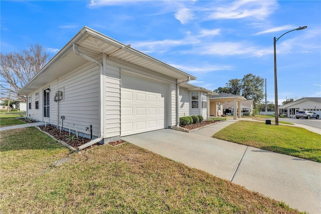 view of home's exterior with a garage and a yard