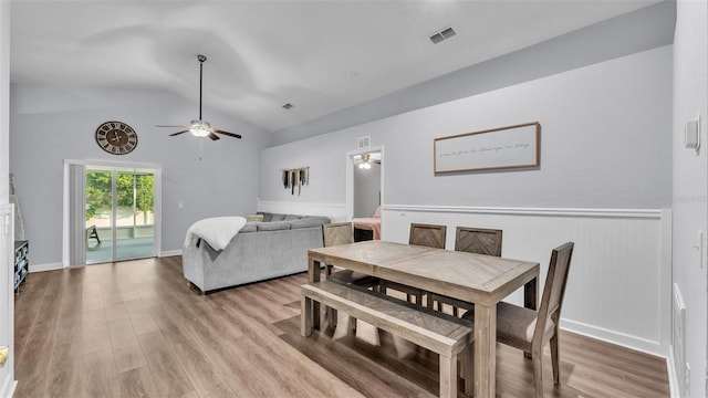 dining area with vaulted ceiling, ceiling fan, and light wood-type flooring