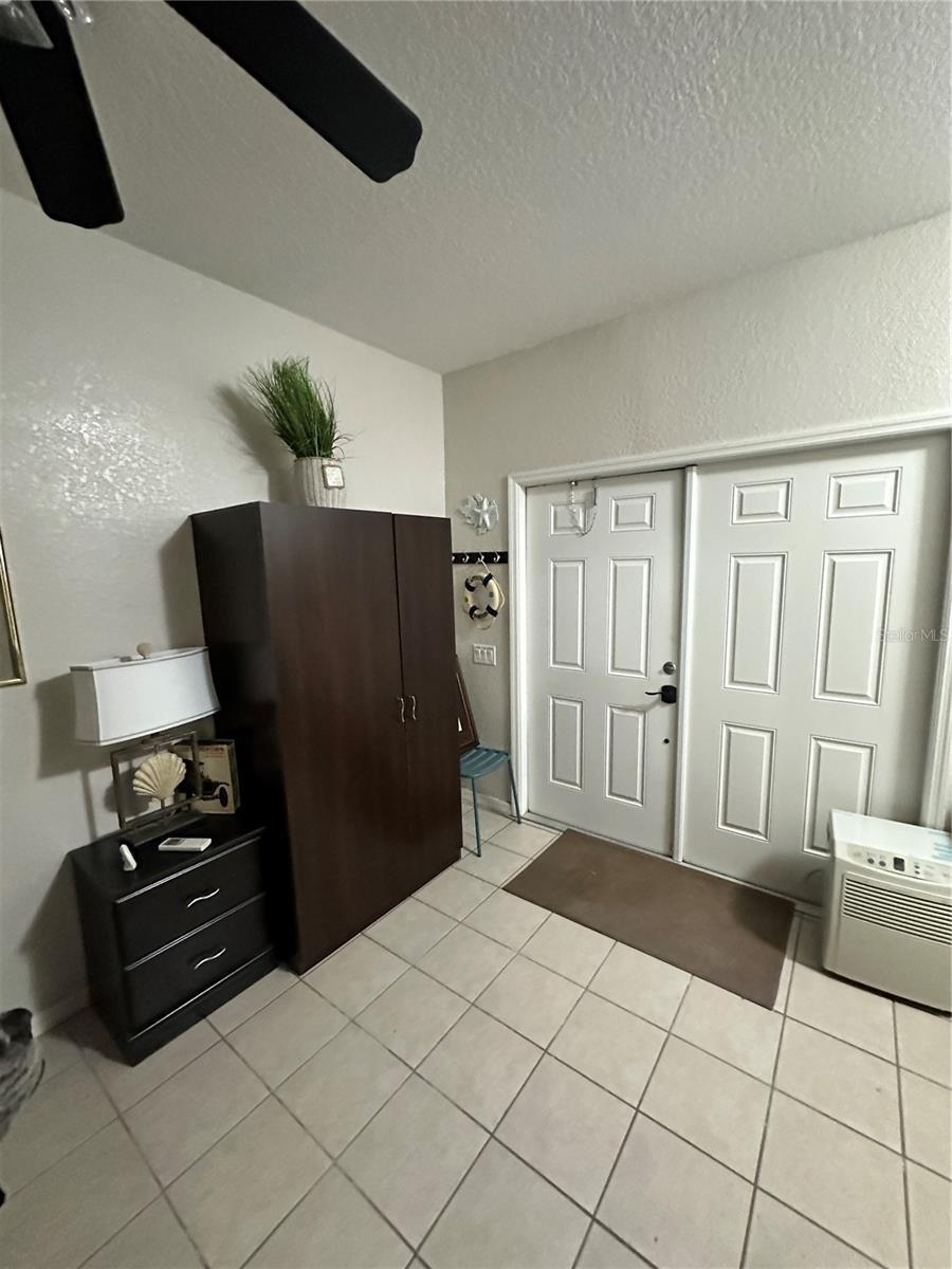 389 Nolane Ln, Polk City, FL 33868 - entryway featuring a textured ceiling and light tile patterned floors