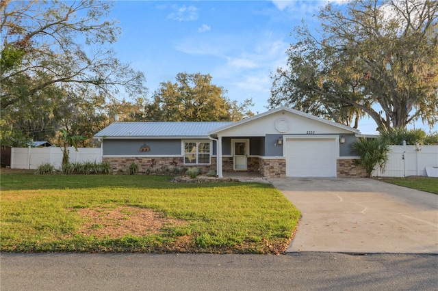 ranch-style house featuring a garage and a front lawn