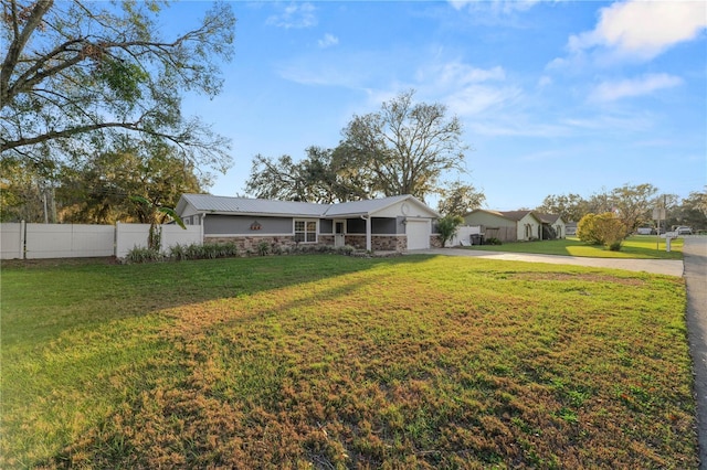 view of front of house featuring a garage and a front yard