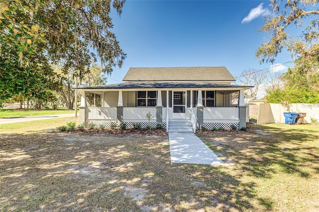 view of front of home with a porch and a front lawn