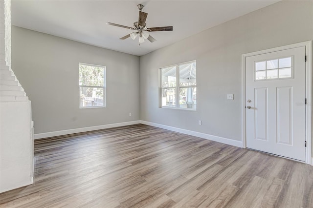 foyer entrance with ceiling fan, plenty of natural light, and light hardwood / wood-style flooring