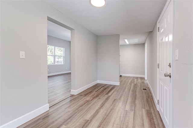 spare room with light wood-type flooring