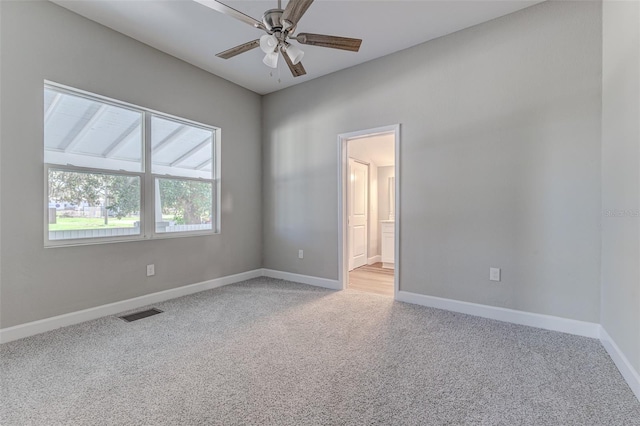 spare room featuring ceiling fan and light colored carpet