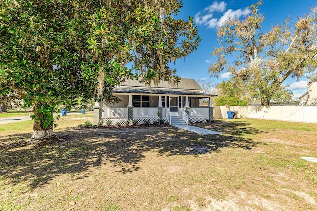 view of front of home with a front yard and covered porch