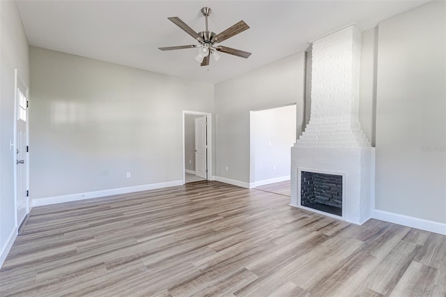 unfurnished living room with a fireplace, light hardwood / wood-style floors, and ceiling fan