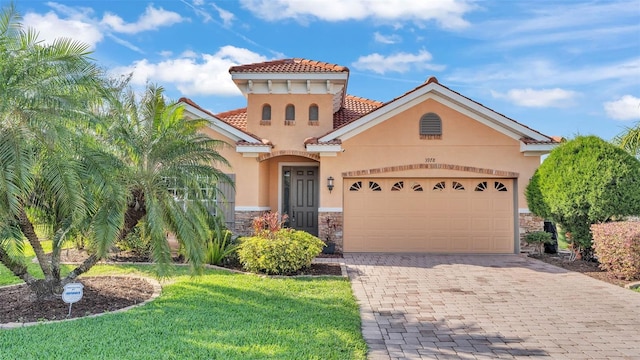 mediterranean / spanish house with stone siding, stucco siding, and an attached garage