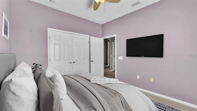 carpeted bedroom featuring a closet, visible vents, ceiling fan, and baseboards