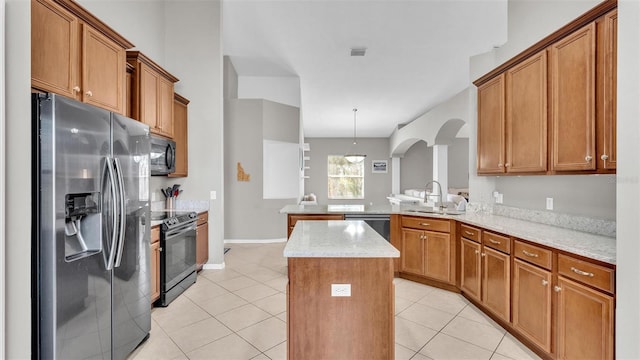 kitchen featuring black appliances, a sink, a center island, a peninsula, and light tile patterned floors