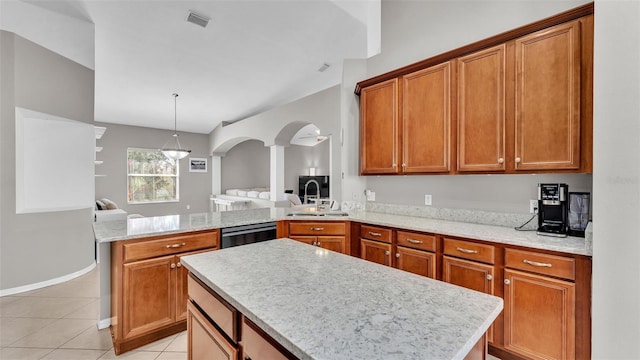 kitchen with dishwashing machine, light tile patterned floors, a peninsula, a sink, and brown cabinets