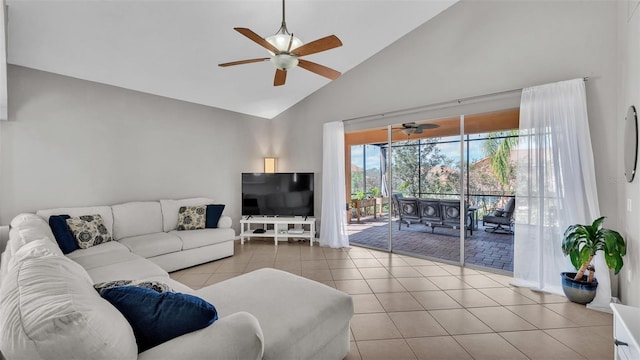 tiled living room with a ceiling fan and high vaulted ceiling