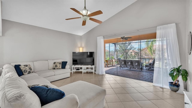 living area featuring ceiling fan, light tile patterned floors, and high vaulted ceiling