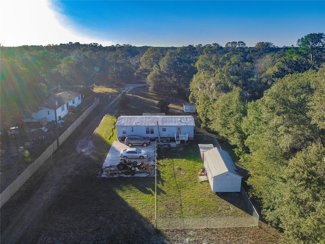 birds eye view of property featuring a view of trees