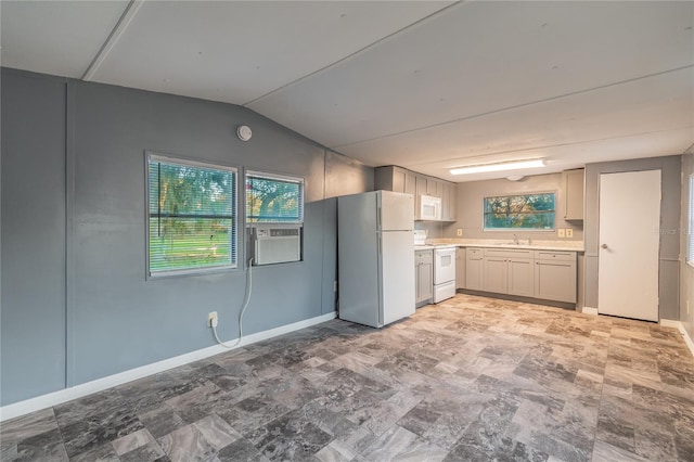 kitchen featuring white appliances, lofted ceiling, light countertops, cooling unit, and a sink