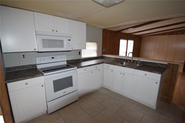 kitchen featuring dark countertops, white appliances, white cabinetry, and a sink