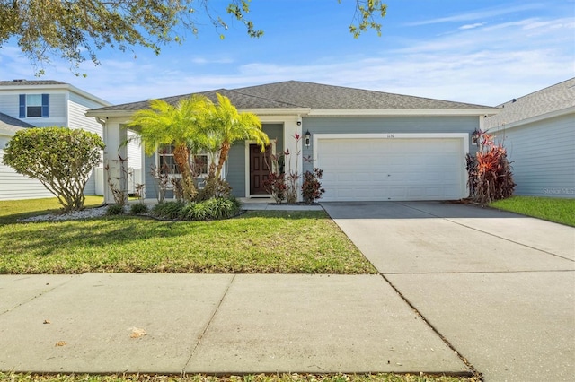 view of front of home with a front lawn and a garage