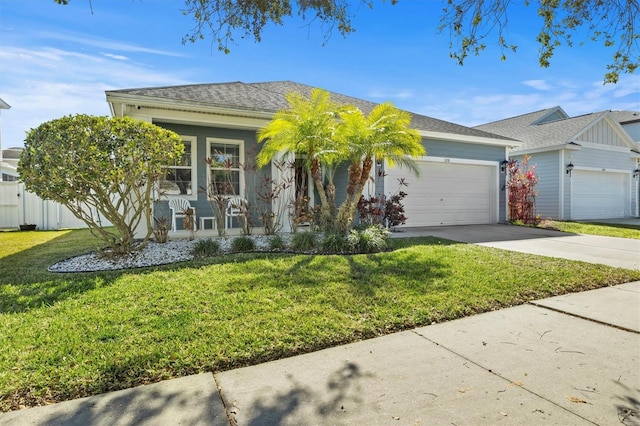 ranch-style home featuring covered porch, a garage, and a front yard