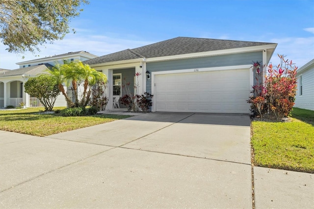 ranch-style house featuring a front lawn and a garage