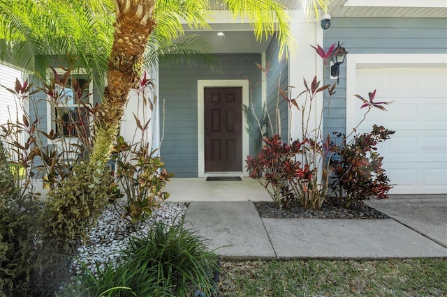 doorway to property with a garage