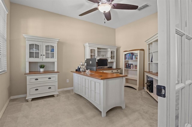 carpeted office featuring ceiling fan