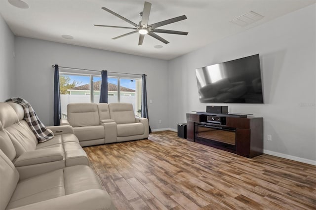 living room with hardwood / wood-style floors and ceiling fan