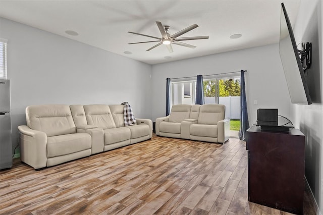 living room featuring ceiling fan and light wood-type flooring