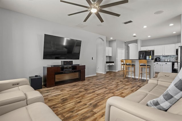 living room with hardwood / wood-style flooring and ceiling fan