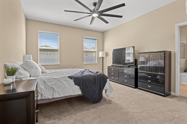 carpeted bedroom featuring ceiling fan and ensuite bathroom