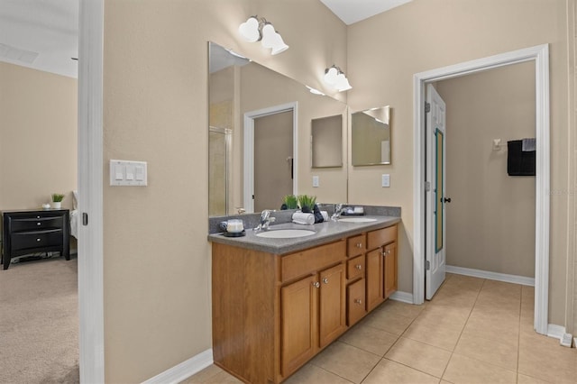 bathroom featuring tile patterned floors, an enclosed shower, and vanity