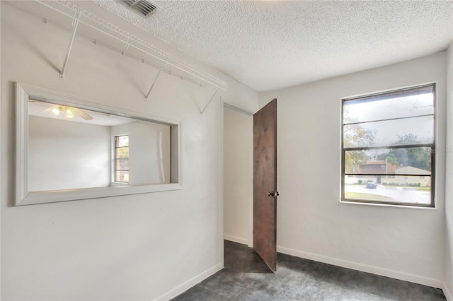 empty room featuring a textured ceiling