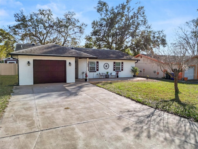 ranch-style home with a garage and a front yard