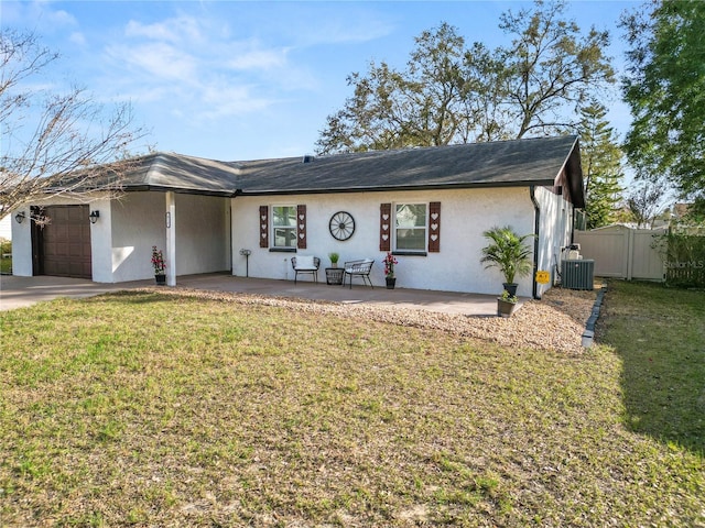 ranch-style house featuring central AC, a garage, a patio, and a front lawn