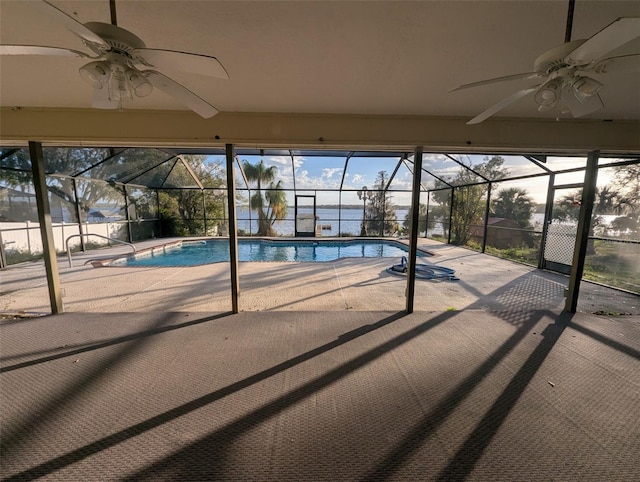 view of swimming pool featuring ceiling fan, a lanai, and a patio