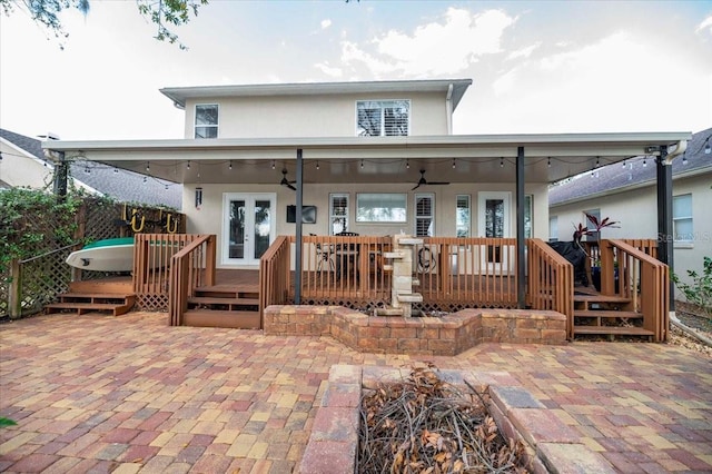 rear view of property featuring a patio, a wooden deck, ceiling fan, and french doors