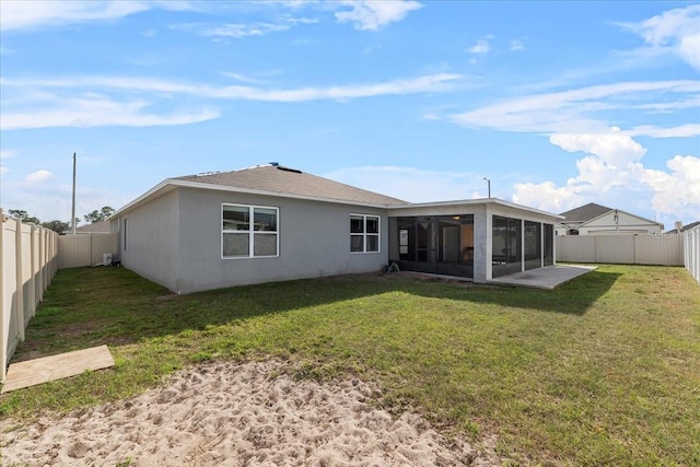 back of house featuring a yard and a sunroom