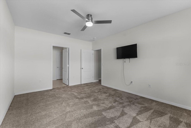 unfurnished bedroom featuring ceiling fan and carpet