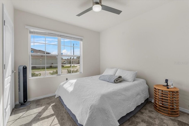 bedroom featuring ceiling fan and carpet