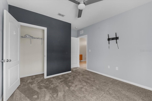 unfurnished bedroom featuring a closet, ceiling fan, and carpet