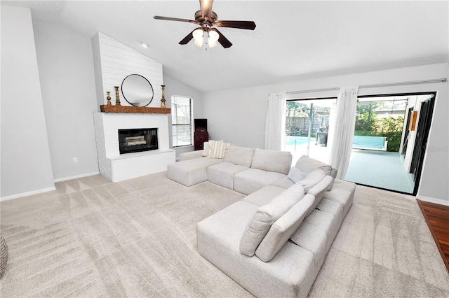 7410 Locksley Ln, Lakeland, FL 33809 - living area featuring a large fireplace, a wealth of natural light, vaulted ceiling, and ceiling fan