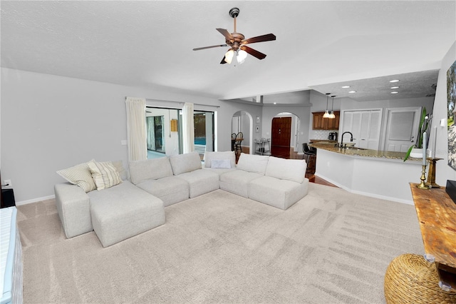 7410 Locksley Ln, Lakeland, FL 33809 - living area with ceiling fan, carpet, lofted ceiling, and arched walkways