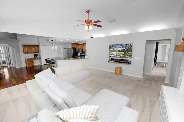 7410 Locksley Ln, Lakeland, FL 33809 - living area with lofted ceiling, baseboards, a ceiling fan, and arched walkways