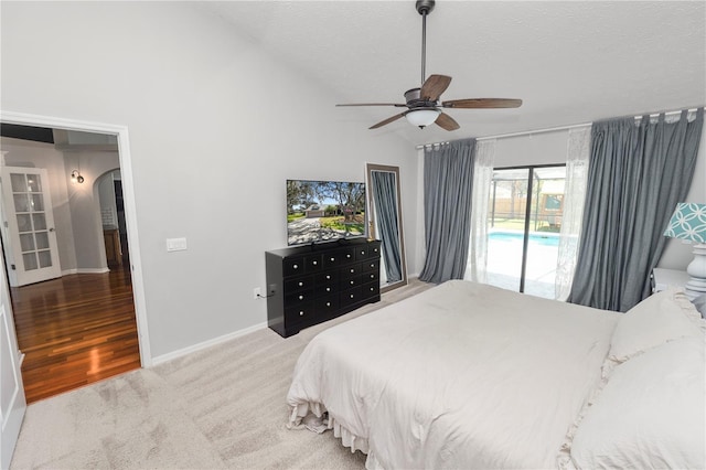 7410 Locksley Ln, Lakeland, FL 33809 - bedroom with a textured ceiling, baseboards, access to outside, vaulted ceiling, and arched walkways