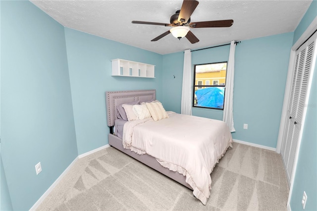 7410 Locksley Ln, Lakeland, FL 33809 - carpeted bedroom featuring a closet, a textured ceiling, baseboards, and a ceiling fan