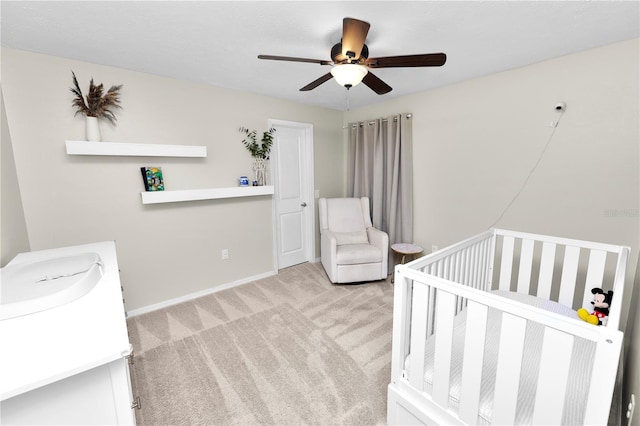 7410 Locksley Ln, Lakeland, FL 33809 - bedroom with a sink, light colored carpet, a nursery area, ceiling fan, and baseboards