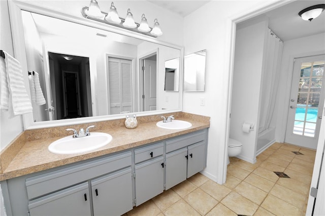 7410 Locksley Ln, Lakeland, FL 33809 - bathroom with a sink, double vanity, toilet, and tile patterned flooring
