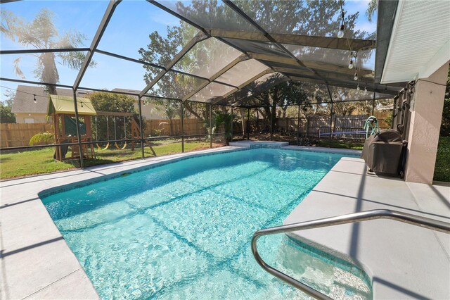 7410 Locksley Ln, Lakeland, FL 33809 - view of swimming pool featuring a fenced backyard, a patio, a fenced in pool, and glass enclosure